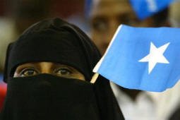 A Somali woman with a Somali flag stuck into her veil watches the inauguration ceremony of the new Somali President Abdullahi Yusuf Ahmed, Thursday, Oct. 14, 2004 in the Kenyan capital Nairobi. Ahmed a former soldier, rebel and warlord was sworn in Thursday as the new president of Somalia in the latest attempt to unite the nation under a central government for the first time since 1991.(AP Photo/Karel Prinsloo)