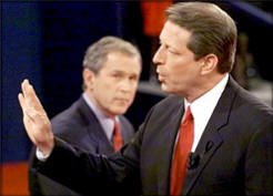 Bush listens as Democratic opponent Al Gore states a point during a debate.